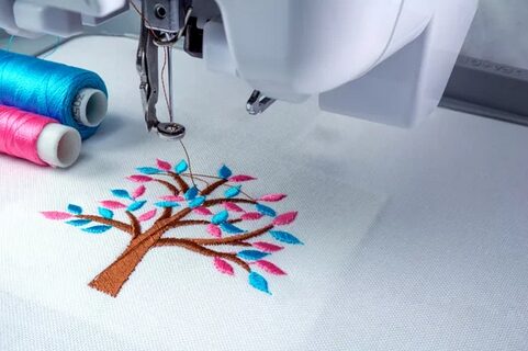 sewing An embroidery machine sewing colourful tree